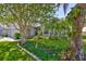 Charming home with a meticulously landscaped front yard, lush greenery, and a well-maintained lawn at 7649 Nottinghill Sky Dr, Apollo Beach, FL 33572