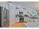 Well-lit kitchen featuring stainless steel appliances, granite countertops, and white cabinetry at 7649 Nottinghill Sky Dr, Apollo Beach, FL 33572