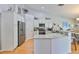 Well-lit kitchen with stainless steel appliances, granite countertops, and ample cabinet space with a breakfast bar at 7649 Nottinghill Sky Dr, Apollo Beach, FL 33572
