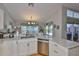 Kitchen area featuring granite countertops, stainless steel appliances, and ample natural light at 7649 Nottinghill Sky Dr, Apollo Beach, FL 33572