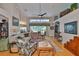 Bright living room with high ceilings, hardwood floors, large windows, and comfortable seating arrangement at 7649 Nottinghill Sky Dr, Apollo Beach, FL 33572