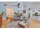 Open-concept living room featuring hardwood floors, natural light, and a seamless flow into the kitchen area at 7649 Nottinghill Sky Dr, Apollo Beach, FL 33572