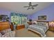 Relaxing main bedroom showcases soothing color palette, large windows, and comfortable seating area at 7649 Nottinghill Sky Dr, Apollo Beach, FL 33572