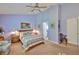 Serene main bedroom includes ensuite bath access, neutral carpet, and ample natural light at 7649 Nottinghill Sky Dr, Apollo Beach, FL 33572