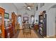 Home office with high ceilings, hardwood floors, decorative accents, and built-in bookcases at 7649 Nottinghill Sky Dr, Apollo Beach, FL 33572