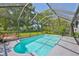 Sparkling pool is surrounded by lush landscaping with screened enclosure at 7649 Nottinghill Sky Dr, Apollo Beach, FL 33572