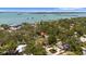 Scenic aerial view of the property, nestled among lush trees with a glimpse of the bay at 8239 26Th N Ave, St Petersburg, FL 33710