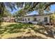 Expansive backyard featuring lush greenery and mature trees providing ample shade and privacy at 8239 26Th N Ave, St Petersburg, FL 33710