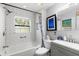 Bright bathroom with a tub, toilet, sink, and window at 8239 26Th N Ave, St Petersburg, FL 33710