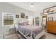 Cozy bedroom with patterned bedding, ceiling fan, and stylish decor at 8239 26Th N Ave, St Petersburg, FL 33710