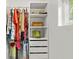 Organized closet with clothes, hats, storage boxes, and shelves at 8239 26Th N Ave, St Petersburg, FL 33710