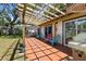 Outdoor deck with a pergola providing shade for the colorful chairs and grill at 8239 26Th N Ave, St Petersburg, FL 33710