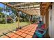 Relaxing outdoor deck with pergola, colorful chairs, and views of the backyard at 8239 26Th N Ave, St Petersburg, FL 33710