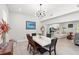 Open-concept dining area featuring a modern light fixture and seamless access to living spaces at 8239 26Th N Ave, St Petersburg, FL 33710