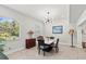Sunlit dining room featuring a modern light fixture and views of lush greenery at 8239 26Th N Ave, St Petersburg, FL 33710