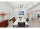 Dining room with a long white marble table, modern light fixture, and stylish decor at 8239 26Th N Ave, St Petersburg, FL 33710