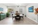 Bright dining room with tile floors, stylish light fixture, and white marble table at 8239 26Th N Ave, St Petersburg, FL 33710