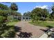 Inviting single-story home with a brick driveway surrounded by tropical greenery at 8239 26Th N Ave, St Petersburg, FL 33710