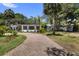 Well-maintained single-story home with a circular driveway and mature trees at 8239 26Th N Ave, St Petersburg, FL 33710