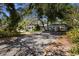 Classic single-story home with a carport and tree-lined driveway at 8239 26Th N Ave, St Petersburg, FL 33710