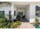 Welcoming covered front porch with seating and lush plants near a decorative front door at 8239 26Th N Ave, St Petersburg, FL 33710