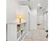 Bright hallway with tiled floors, storage shelves, and a lamp at 8239 26Th N Ave, St Petersburg, FL 33710