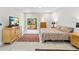 Spacious main bedroom featuring a comfortable bed, TV, sliding glass door and tile flooring at 8239 26Th N Ave, St Petersburg, FL 33710