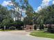Gated community entrance with brick paved road, mature trees and landscaping at 9481 Highland Oak Dr # 1202, Tampa, FL 33647