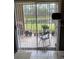 Enclosed patio with sliding doors overlooking a serene pond and lush greenery at 9481 Highland Oak Dr # 1202, Tampa, FL 33647