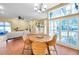 A large dining room has lots of natural light, an elegant chandelier, and a view to the living room at 980 Live Oak Ne Ave, St Petersburg, FL 33703