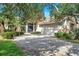 Charming single-Gathering home showcasing a well-manicured lawn, a spacious driveway, and mature trees offering shade at 980 Live Oak Ne Ave, St Petersburg, FL 33703