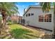Side view of the home showcasing the manicured lawn and a screened-in porch at 980 Live Oak Ne Ave, St Petersburg, FL 33703