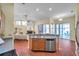 An open kitchen with stainless steel appliances, terra cotta tile flooring and view of the living room at 980 Live Oak Ne Ave, St Petersburg, FL 33703