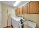 Well-equipped laundry room with washer, dryer, and ample storage cabinets at 980 Live Oak Ne Ave, St Petersburg, FL 33703