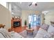 A cozy living room features terra cotta tile flooring, a fireplace, and sliding glass doors to the lanai at 980 Live Oak Ne Ave, St Petersburg, FL 33703