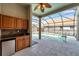 Enclosed patio with a wet bar, outdoor kitchen and swimming pool at 980 Live Oak Ne Ave, St Petersburg, FL 33703