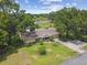 Aerial view of home with well-maintained lawn and mature trees at 1703 Ryan Dr, Lutz, FL 33549