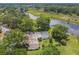 Aerial view of home with a pool and a large, private backyard near a lake at 1703 Ryan Dr, Lutz, FL 33549