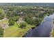 Aerial view of a waterfront home with lush trees at 1703 Ryan Dr, Lutz, FL 33549