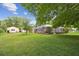 Expansive backyard featuring a screened-in lanai and separate storage building at 1703 Ryan Dr, Lutz, FL 33549