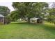 Expansive backyard with a gazebo, a deck and serene lake views at 1703 Ryan Dr, Lutz, FL 33549