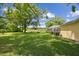 Sprawling backyard with mature trees and lush landscaping at 1703 Ryan Dr, Lutz, FL 33549
