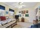 Cozy bedroom with ceiling fan, a window with blinds, and vintage decorations and matching bedding at 1703 Ryan Dr, Lutz, FL 33549