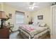 Well lit bedroom with a large window, neutral color scheme, and traditional decor at 1703 Ryan Dr, Lutz, FL 33549