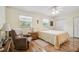 Cozy bedroom with ample natural light, chair, and hardwood flooring throughout at 1703 Ryan Dr, Lutz, FL 33549