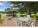 Large wooden deck with gazebo, fire pit, and seating area at 1703 Ryan Dr, Lutz, FL 33549