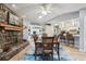 Open dining area with stone fireplace and seating at kitchen bar at 1703 Ryan Dr, Lutz, FL 33549