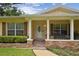 Charming front porch with brick accents, columns, and a cozy bench at 1703 Ryan Dr, Lutz, FL 33549