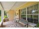 Covered front porch seating area with patterned brick flooring at 1703 Ryan Dr, Lutz, FL 33549