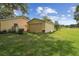 Exterior view of a home showing a separate garage and spacious lawn at 1703 Ryan Dr, Lutz, FL 33549